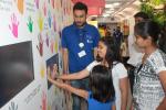 Children enjoying demo of hand print technology in Science Express Climate Action Special 